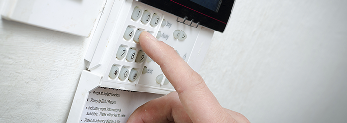 Man setting an alarm system