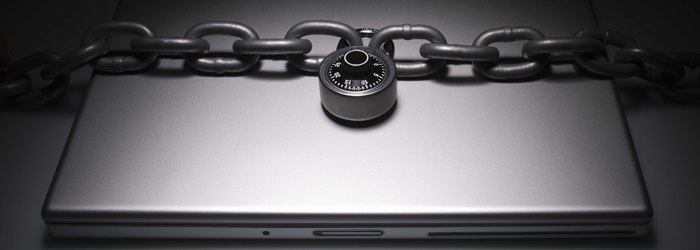 A laptop secured with a chain and padlock