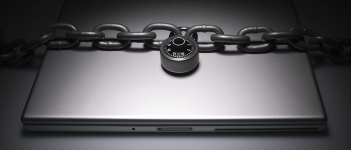 A laptop secured with a chain and padlock