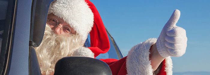 Santa Claus driving a car.