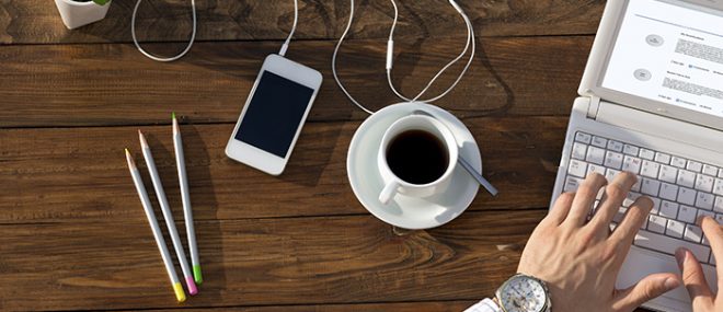 working at a table with coffee and smartphone