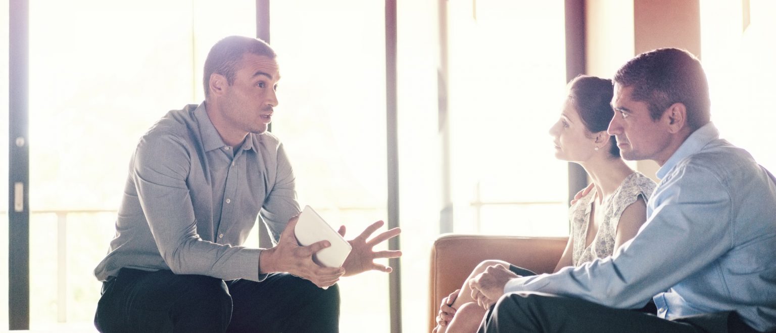 Couple meeting with their small business insurance broker.