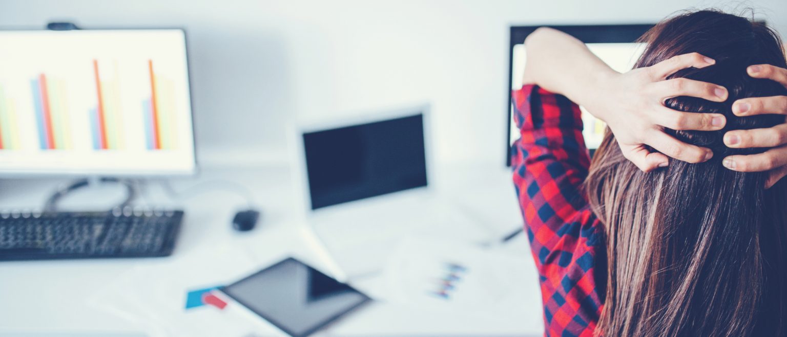 Worried small business woman at her computer.