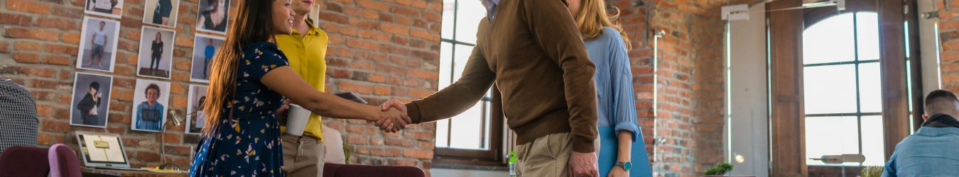 Two Young Business People Shake Hands