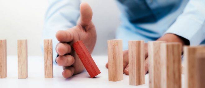 toppling dominoes showing business continuity concept