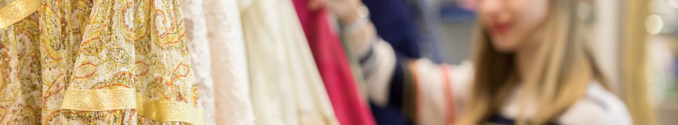 Young woman browsing a rack of clothing