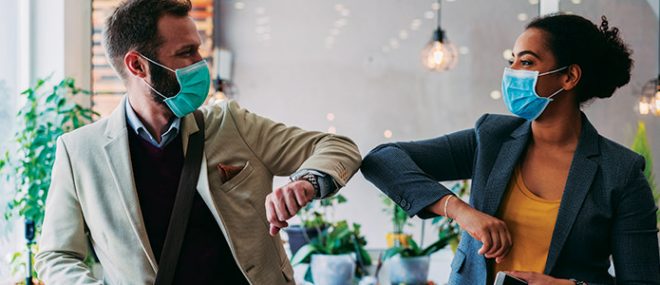 Business people greeting during pandemic with elbow bump