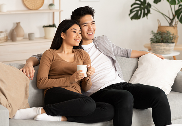 A young couple sitting on a couch.