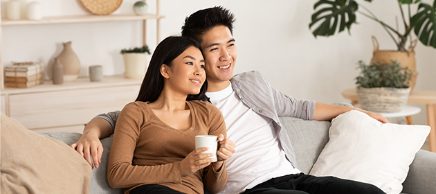 A young couple sitting on a couch.