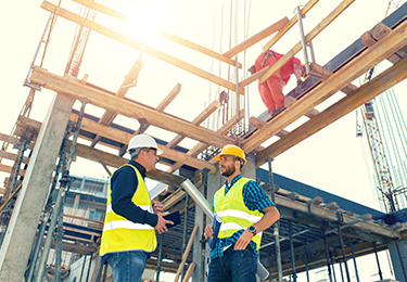 Two contractors at a construction site.