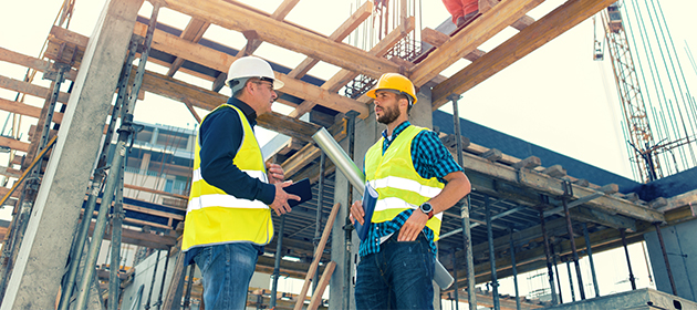 Two contractors at a construction site.