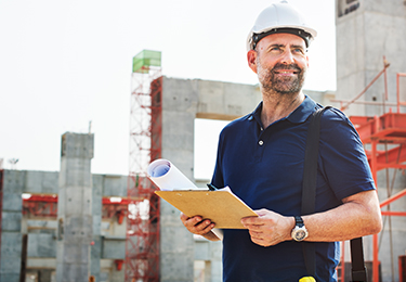 A general contractor overlooking a construction site.