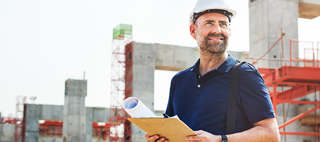 A general contractor overlooking a construction site.