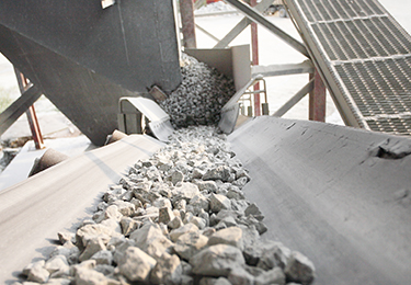 White concrete rocks on a conveyer belt.