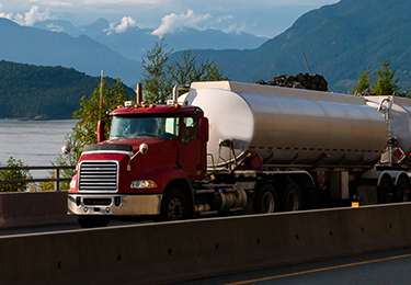 A tanker truck driving on a road.