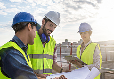 Construction architect contractor GM looking over blue print