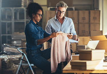 two business owner inspecting their garment