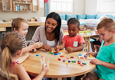 educator smiling at children