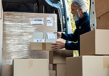 A man unloading a delivery truck.