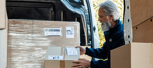 A man unloading a delivery truck.