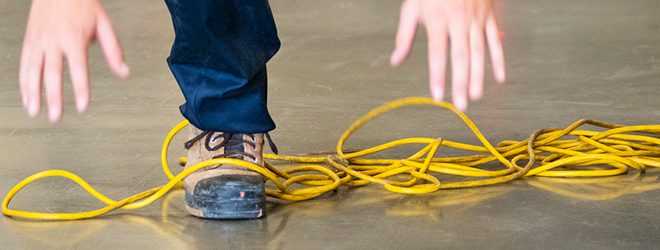 A worker’s foot tangled up in an electrical cord.