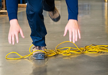 A worker’s foot tangled up in an electrical cord.