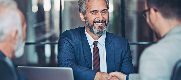 A male broker shaking hands with a client.