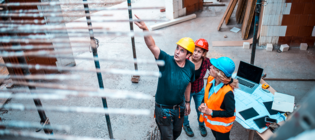 A risk service team member assessing risk on a construction site.