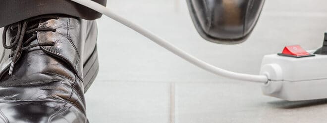 A worker’s foot tangled up in an electrical cord.