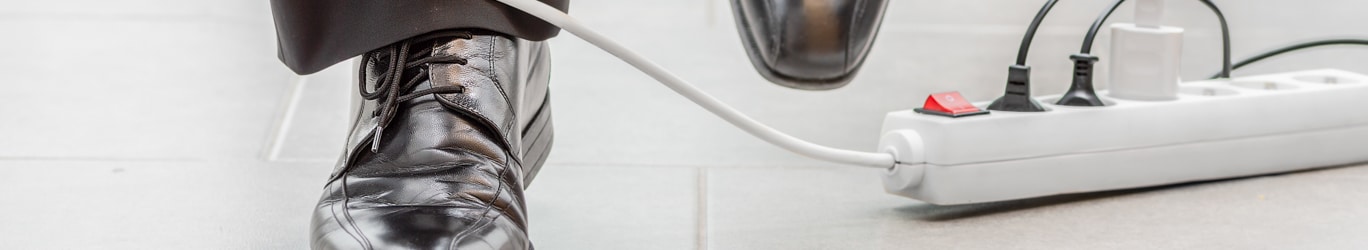 A worker’s foot tangled up in an electrical cord.