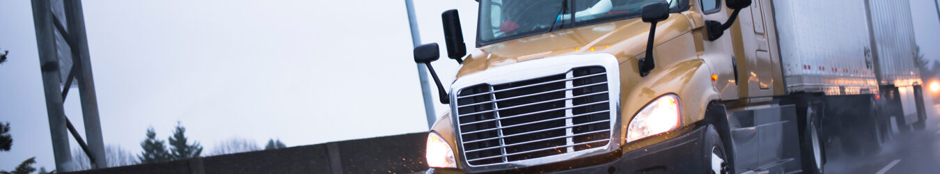 Semi truck driving on wet highway