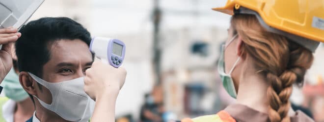 construction worker doing a temperature check