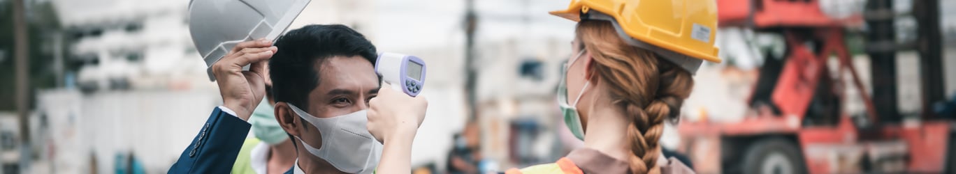 construction worker doing a temperature check