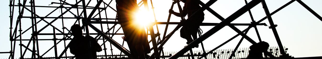 Construction workers working on scaffolding.