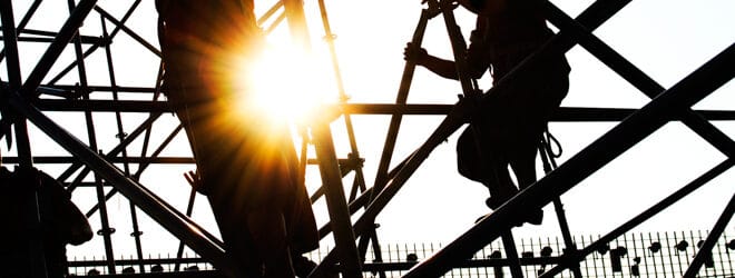 Construction workers working on scaffolding.