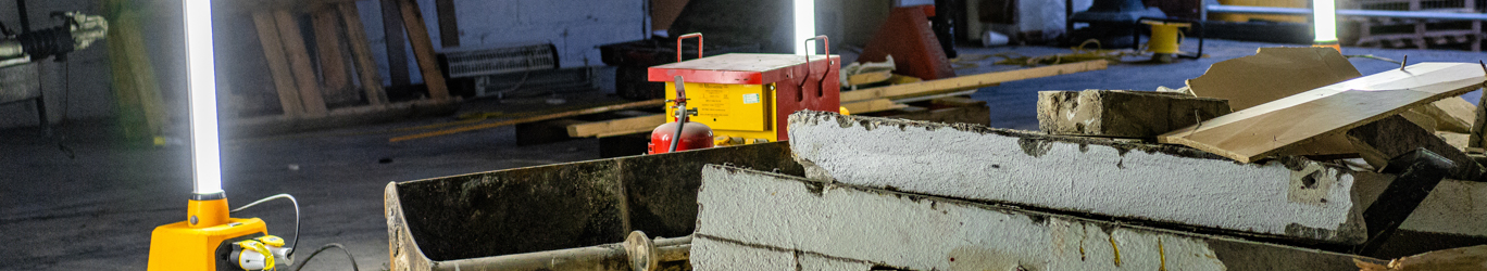 Demolition area lit up by portable lighting.