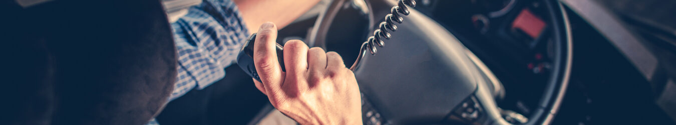 Semi truck driver talking to other truck drivers through the radio.