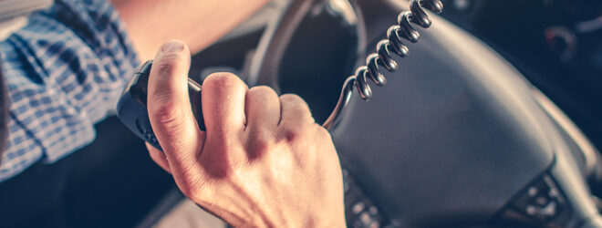 Semi truck driver talking to other truck drivers through the radio.