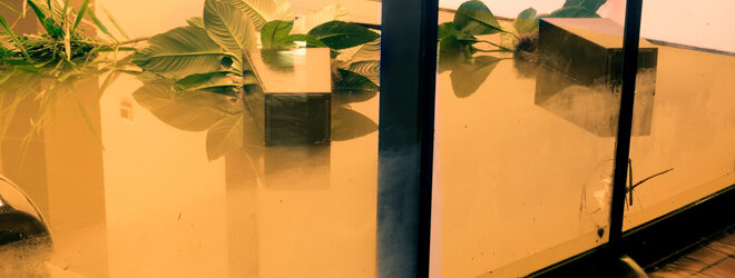 Water flowing through doors from a flooded office.