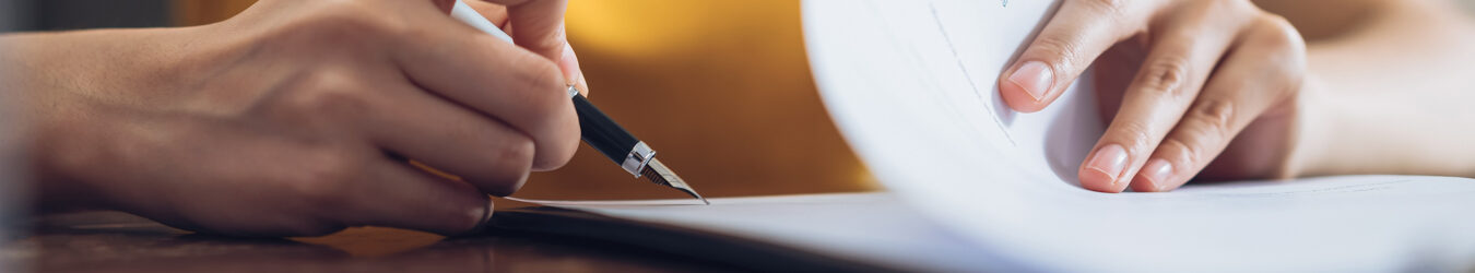 Woman signing document.